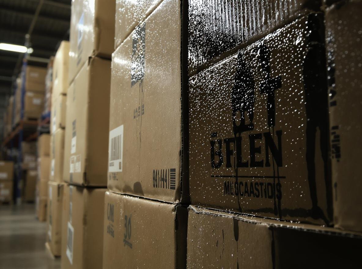 Corrugated boxes showing humidity damage in warehouse environment
