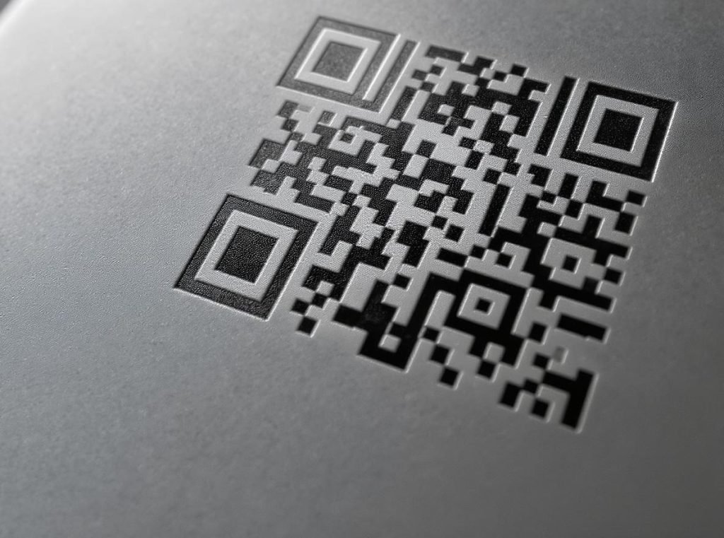 Close-up QR code printed on luxury product packaging showing technical precision