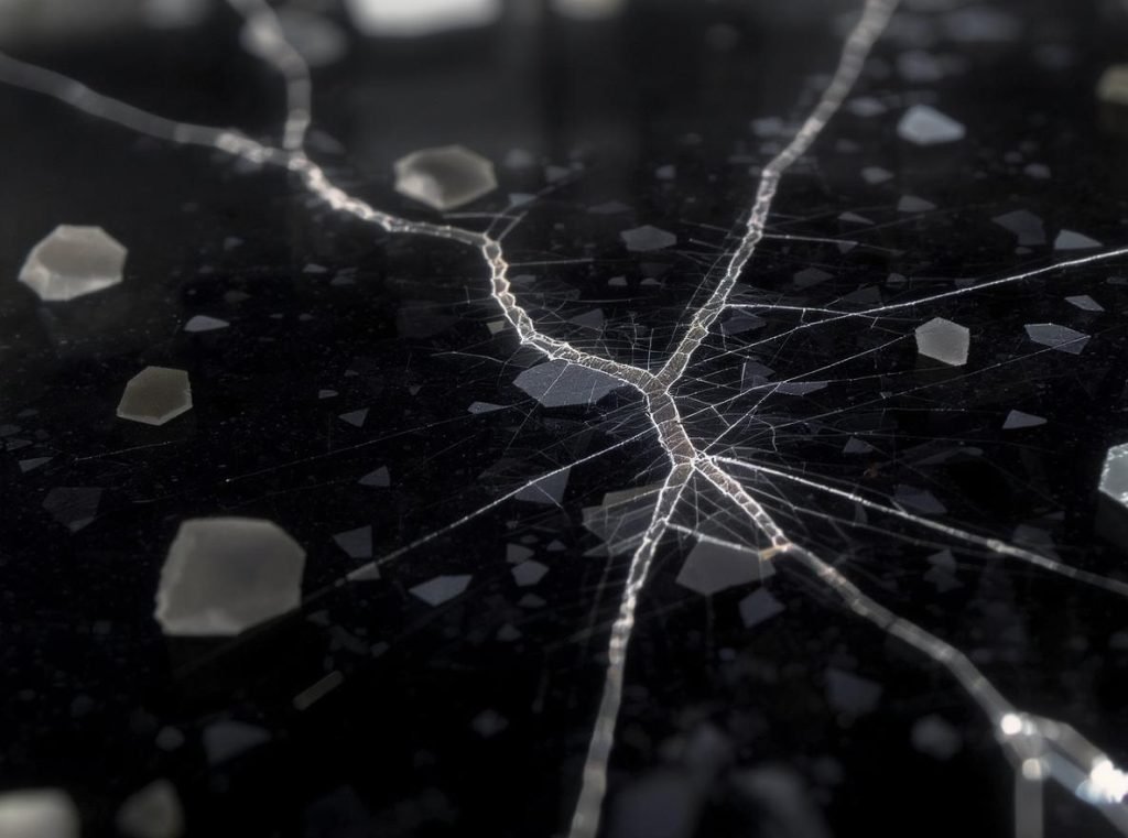 Microscopic view of glass crack propagation showing why glass and ceramics are difficult to package