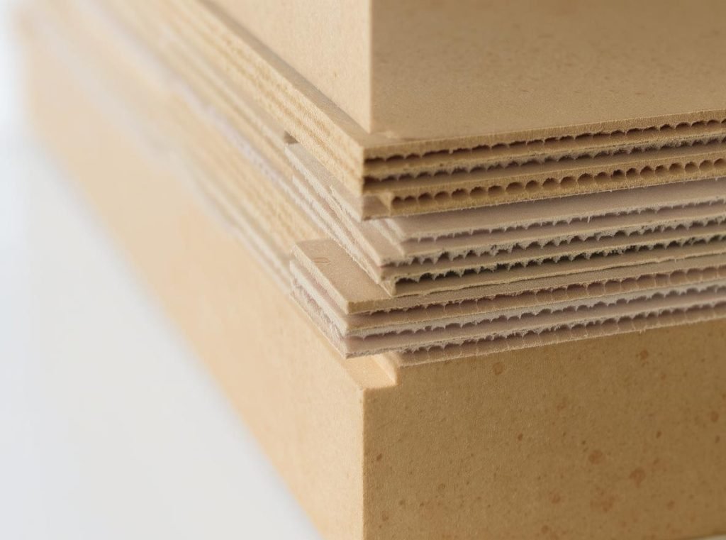Hinged lid rigid box construction showing protective layers and superior material thickness