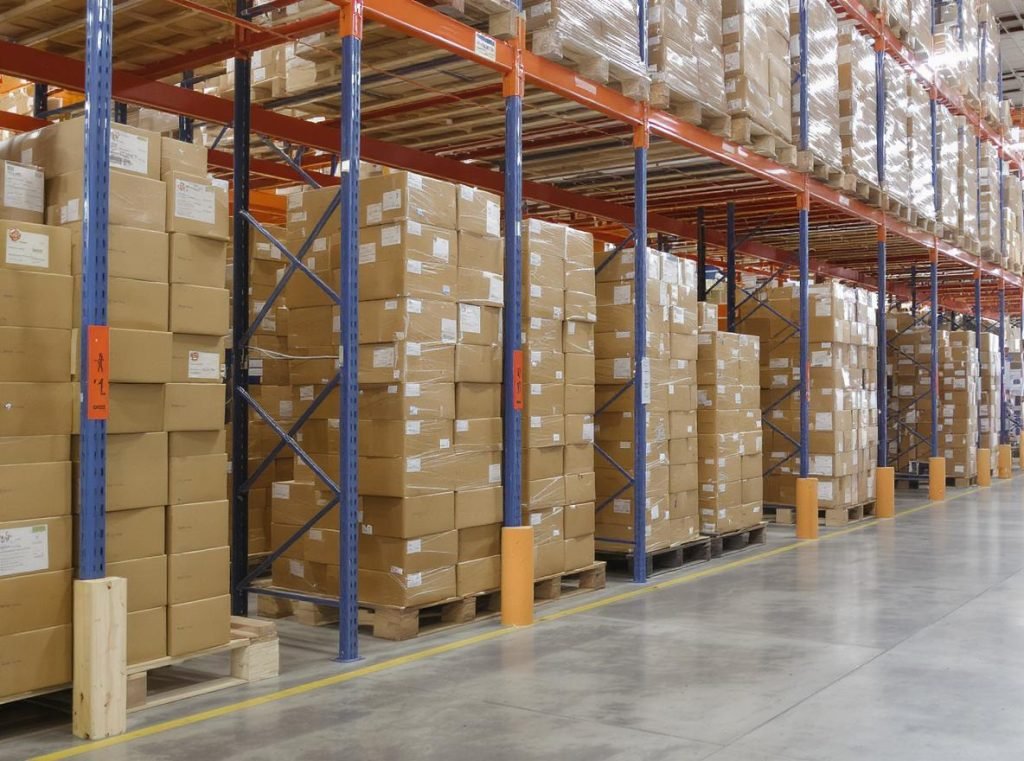 Corrugated boxes properly positioned flat on wooden pallets elevated above warehouse floor