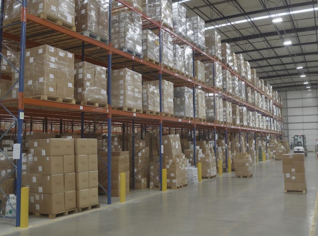 Large warehouse with stacked packaging boxes demonstrating volume leverage for negotiations