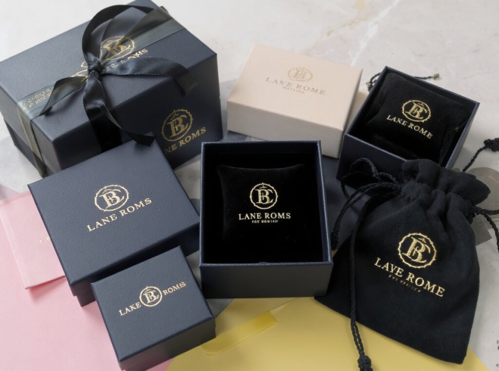 Customized jewelry packaging with embossed logos, foil stamping, and branded pouches showing personalization options